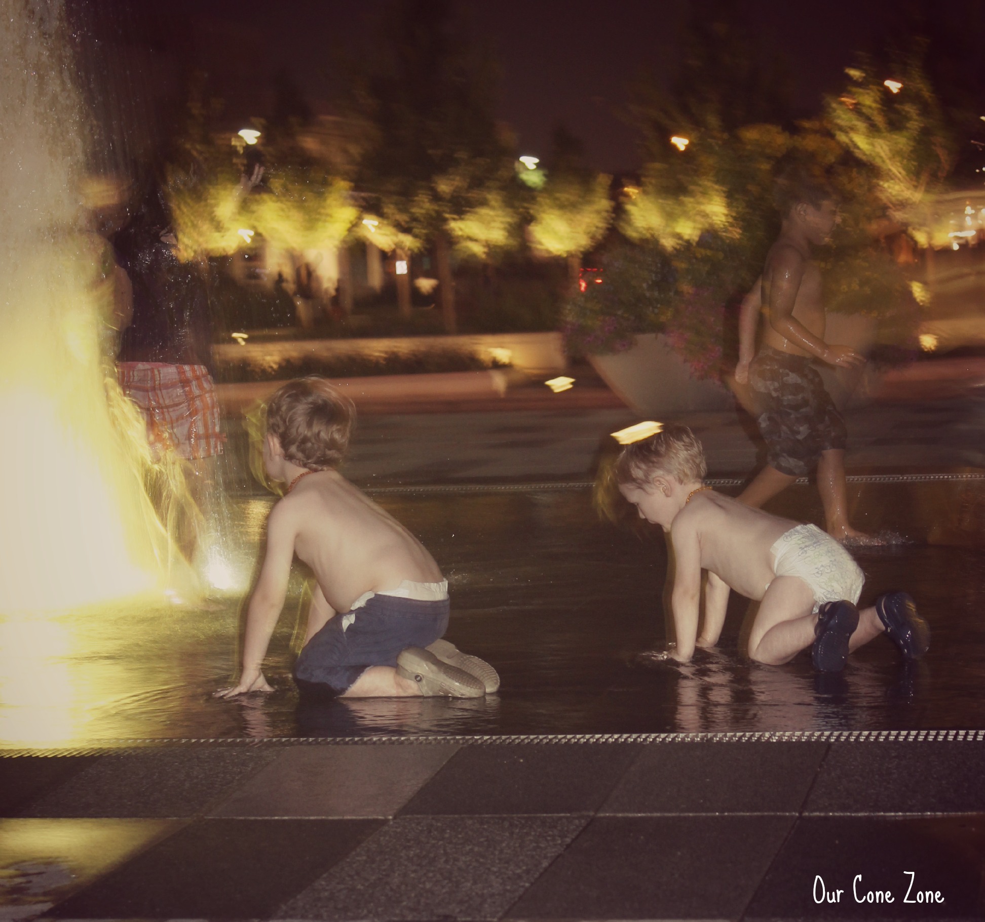 Boys playing in the fountain